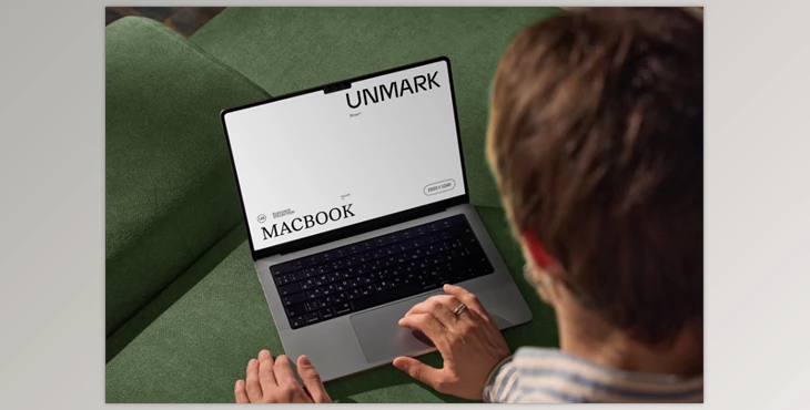 Gumroad - Download Mockup Macbook on the couch with the hands of a man