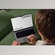 Gumroad - Download Mockup Macbook on the couch with the hands of a man