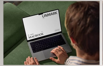Gumroad - Download Mockup Macbook on the couch with the <span class='badge badge-warning'>hands</span> of a man