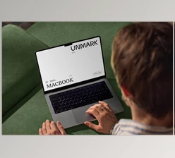 Gumroad - Download Mockup Macbook on the couch with the hands of a man